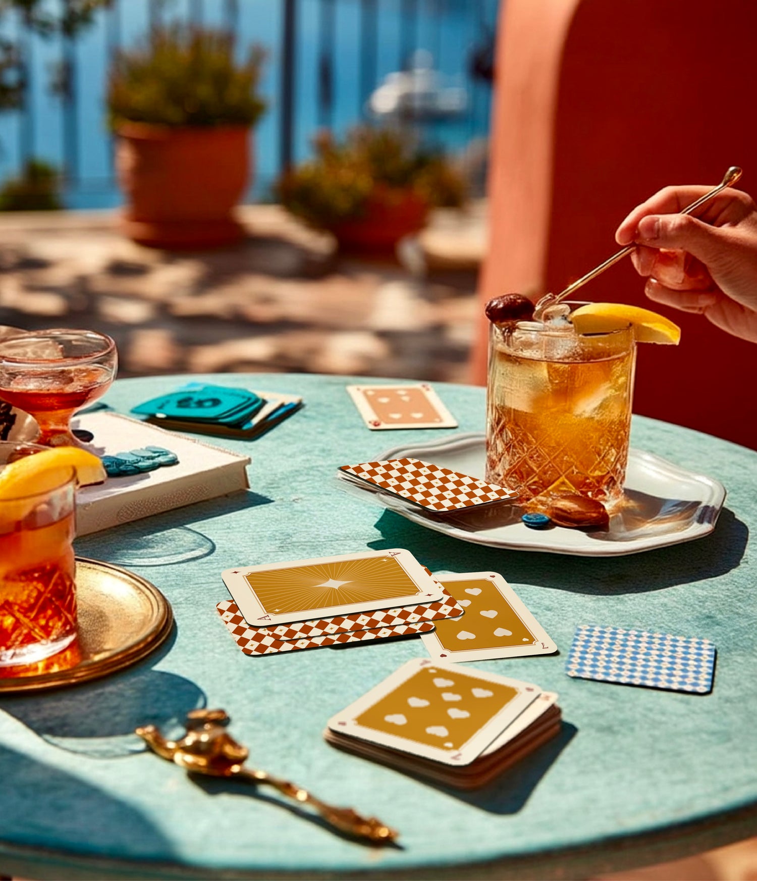 Outdoor setting with drinks and playing cards on a table